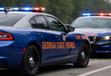 Georgia State Patrol vehicles with emergency lights on along a highway