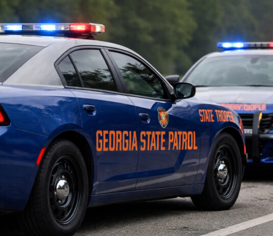 Georgia State Patrol vehicles with emergency lights on along a highway