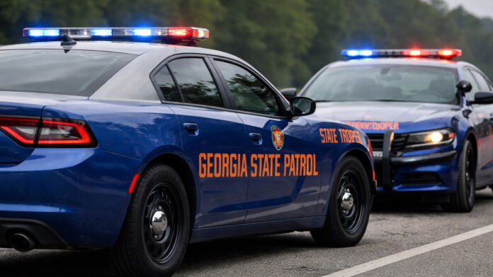 Georgia State Patrol vehicles with emergency lights on along a highway